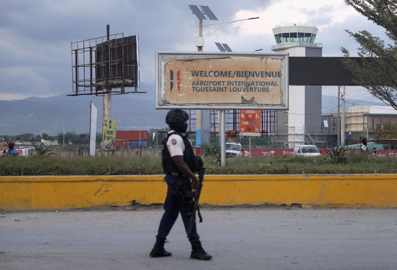 © Reuters. A police officer stands at one of the entrances of Toussaint Louverture International Airport, which was shut since last month and has been reopened by Haitian authorities, even as the U.S. Federal Aviation Administration watchdog extended a ban on U.S. airlines flying there, in Port-au-Prince, Haiti, December 11, 2024. REUTERS/Ralph Tedy Erol