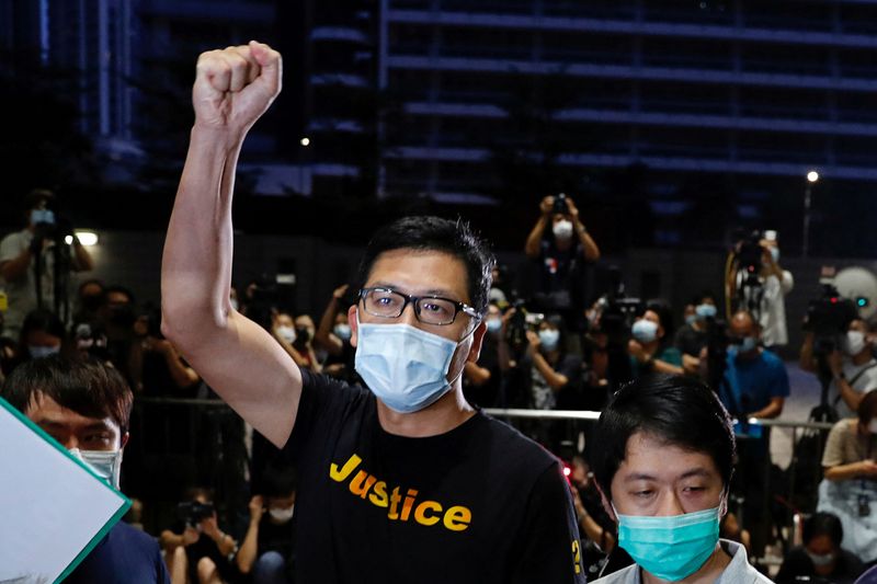 © Reuters. FILE PHOTO: Democratic Party lawmakers Lam Cheuk-ting and Ted Hui Chi-fung react after being released on bail over anti-government protests in July 2019 at West Kowloon Magistrates' Courts, in Hong Kong, China August 27, 2020. REUTERS/Tyrone Siu/File Photo