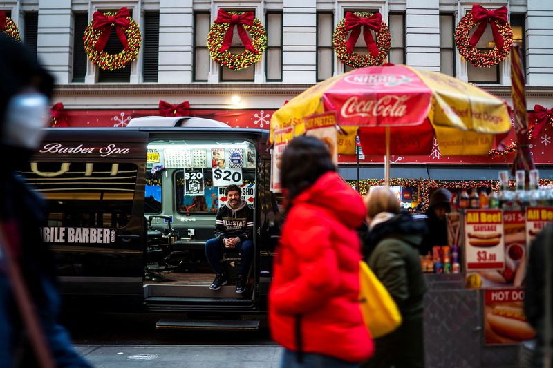 &copy; Reuters. An independent barber waits for customers on his van in a local street, in New York, U.S., December 25, 2023. REUTERS/Eduardo Munoz/File Photo