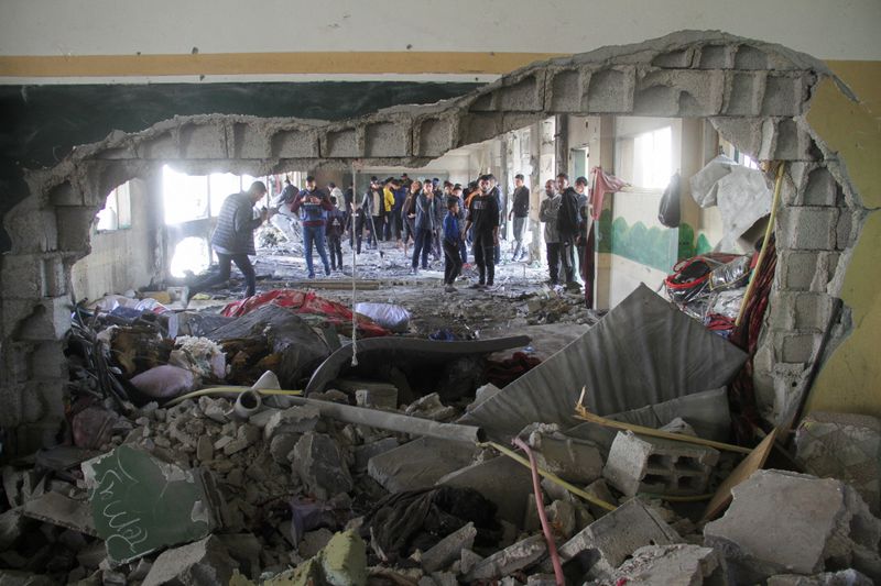 &copy; Reuters. Palestinians inspect the site of an Israeli strike on a school sheltering displaced people, amid the Israel-Hamas conflict, in Gaza City December 14, 2024. REUTERS/Mahmoud Issa