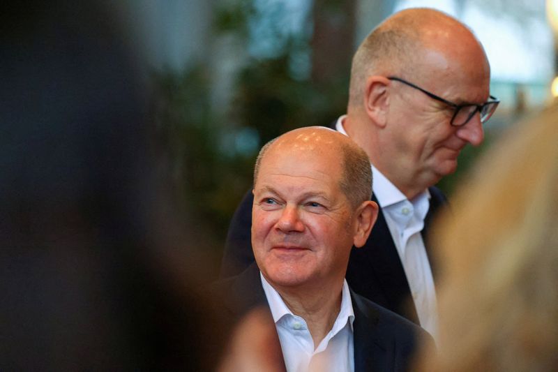 © Reuters. FILE PHOTO: German Chancellor Olaf Scholz reacts after the vote, as he and Dietmar Woidke, Brandenburg state premier, attend a meeting of the Social Democratic Party of Germany (SPD) where Brandenburg regional representatives meet to vote candidates for the February 2025 snap elections, in Potsdam, Germany, December 14, 2024. REUTERS/Nadja Wohlleben/File Photo