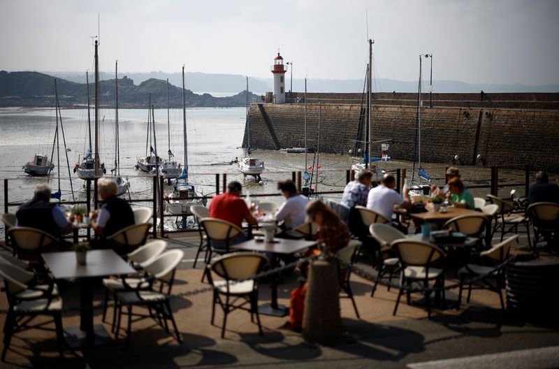 © Reuters. FILE PHOTO: People sit on the terrace of a restaurant in front of the harbour of Erquy, Brittany, France, September 19, 2024. REUTERS/Stephane Mahe/File Photo