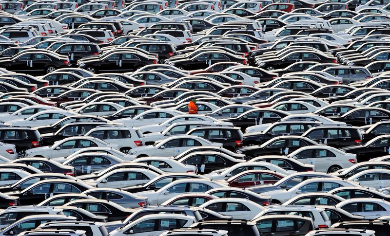 © Reuters. A worker walks along rolls of Mercedes cars at a shipping terminal in the harbor of the town of Bremerhaven, Germany, March 8, 2012. REUTERS/Fabian Bimmer/File photo