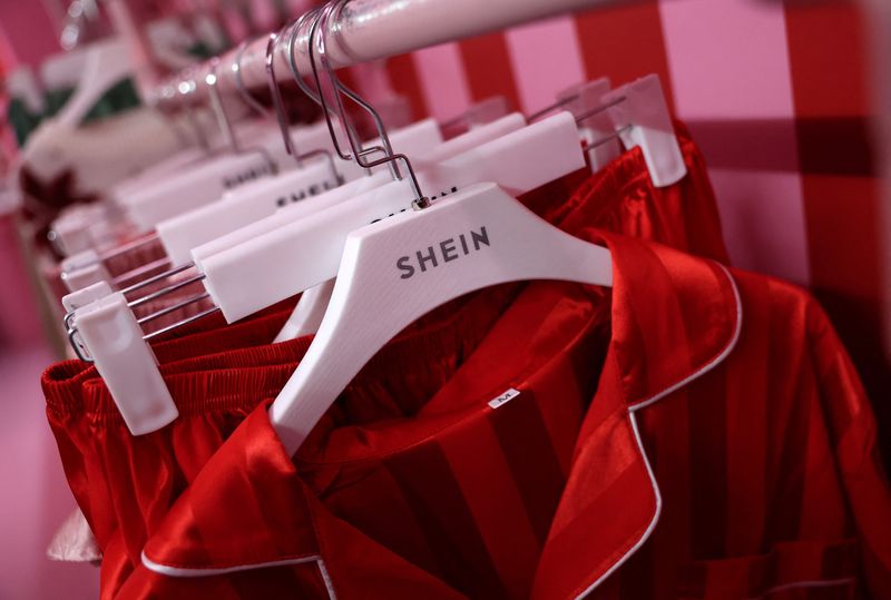 &copy; Reuters. A company logo for fashion brand Shein is seen on a rail of clothing on its Christmas bus as part of a nationwide promotional tour in Liverpool, Britain, December 14, 2024. REUTERS/Phil Noble