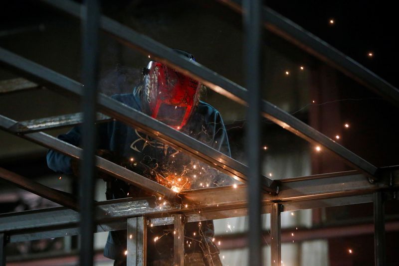 © Reuters. FILE PHOTO: Eric Hall welds a trailer at Look Trailers cargo trailer manufacturing facility in Middlebury, Indiana, U.S., April 1, 2021. Picture taken April 1, 2021.  REUTERS/Eileen T. Meslar/File Photo