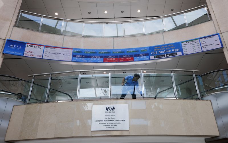 &copy; Reuters. FILE PHOTO: A woman cleans a glass railing at Colombo Stock Exchange premises in Colombo, Sri Lanka June 7, 2023. REUTERS/Dinuka Liyanawatte/File Photo