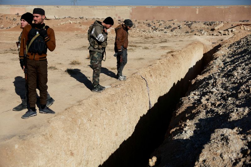 &copy; Reuters. Fighters of the ruling Syrian body inspect the site of a mass grave from the rule of Syria's Bashar al-Assad, according to residents, after the ousting of al-Assad, in Najha, Syria, December 17, 2024. REUTERS/Ammar Awad   