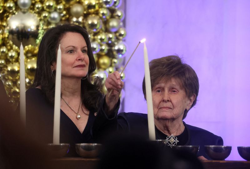 &copy; Reuters. FILE PHOTO: Holocaust survivor Bronia Brandman and Ambassador Michele Taylor light a menorah as U.S. President Joe Biden and first lady Jill Biden host a Hanukkah holiday reception at the White House in Washington, U.S., December 19, 2022. REUTERS/Leah Mi