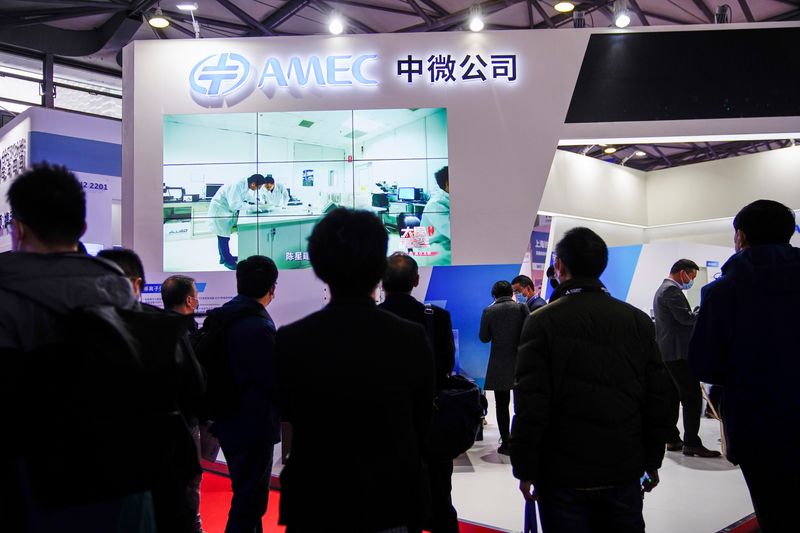 © Reuters. FILE PHOTO: People visit a booth of the Advanced Micro-Fabrication Equipment Inc. China (AMEC) at Semicon China, a trade fair for semiconductor technology, in Shanghai, China March 17, 2021. REUTERS/Aly Song/File Photo