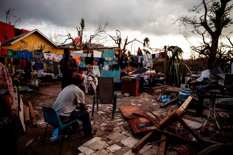 &copy; Reuters. A man sits in the backyard of a house, in the aftermath of Cyclone Chido, in Pamandzi, Mayotte, France, December 17, 2024. REUTERS/Gonzalo Fuentes    