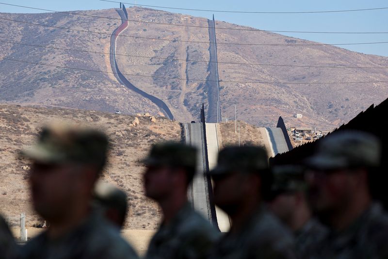 &copy; Reuters. FILE PHOTO: Members of California national guard stand near the wall on the United States and Mexico border, in San Diego, California, U.S. December 5, 2024. REUTERS/Mike Blake/File Photo