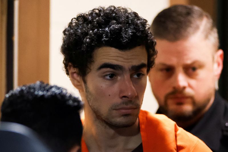 &copy; Reuters. FILE PHOTO: Luigi Mangione, 26, a suspect in the New York City killing of UnitedHealth executive Brian Thompson, is escorted after an extradition hearing at Blair County Court House in Hollidaysburg, Pennsylvania, U.S. December 10, 2024. REUTERS/Eduardo M