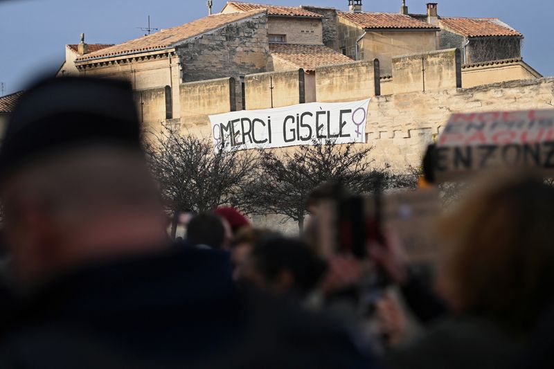 &copy; Reuters. A banner which reads " Thank you Gisele" hangs on the city wall as people gather in support of Frenchwoman Gisele Pelicot, the victim of an alleged mass rape orchestrated by her then-husband Dominique Pelicot at their home in the southern French town of M