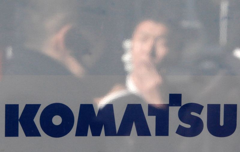 &copy; Reuters. FILE PHOTO: A man is reflected on the logo of Komatsu Ltd outside the company's headquarters in Tokyo January 29, 2013. REUTERS/Shohei Miyano/File Photo/File Photo