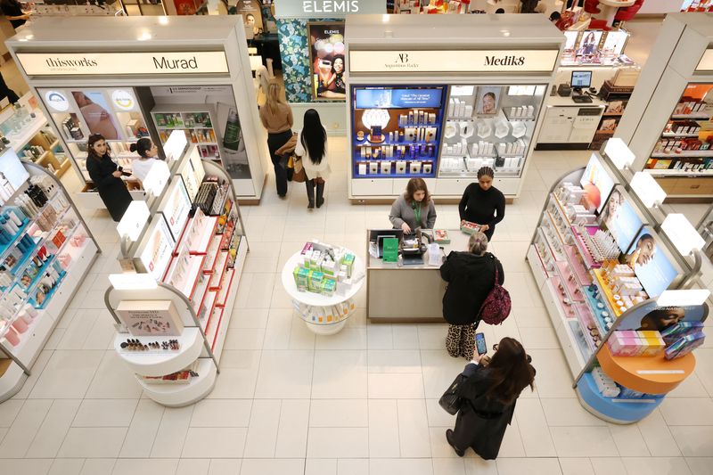 © Reuters. FILE PHOTO: People visit the beauty department at the John Lewis retail store on Oxford Street in London, Britain, October 24, 2024. REUTERS/Hollie Adams/File Photo