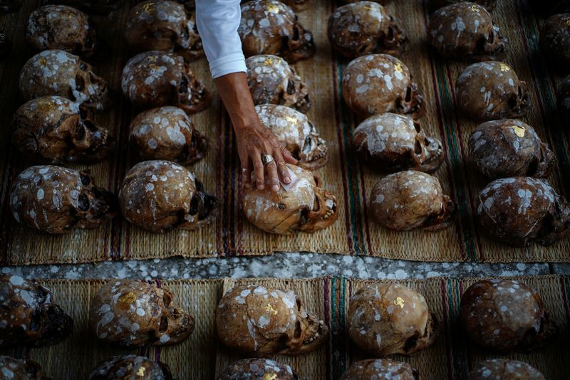 &copy; Reuters. A volunteer places a gold leaf on a human skull during a Lang Pa Cha mass cleansing ceremony for unclaimed bodies, at the Sawang Metta Thammasathan Foundation in Nakhon Ratchasima province, Thailand, June 1, 2024. As the day of cremation draws near, the v