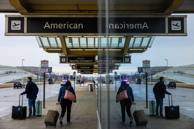 © Reuters. Travelers arrive for departing flights as American Airlines resumed flights after a technical glitch forced the carrier into an hour-long layover, disrupting travel for thousands on Christmas Eve, the one of the busiest times of the year, at Ronald Reagan Washington National Airport. in Arlington, Virginia, United States on December 24, 2024. REUTERS/Anna Rose Layden