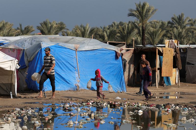 Displaced Gaza newborn freezes to death and twin fights for his life as rain floods tents