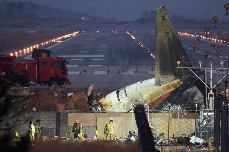 © Reuters. Rescuers work near the wreckage of a Jeju Air plane that ran off the runway and crashed at Muan International Airport, Muan, South Korea December 30, 2024. REUTERS/Kim Hong-Ji