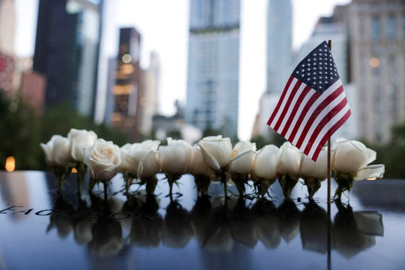 &copy; Reuters. FILE PHOTO: A U.S. national flag and flowers are placed at the 9/11 Memorial and Museum pool on the day of the 23rd anniversary of the September 11, 2001 attacks on the World Trade Center, in the Manhattan borough of New York City, U.S., September 11, 202