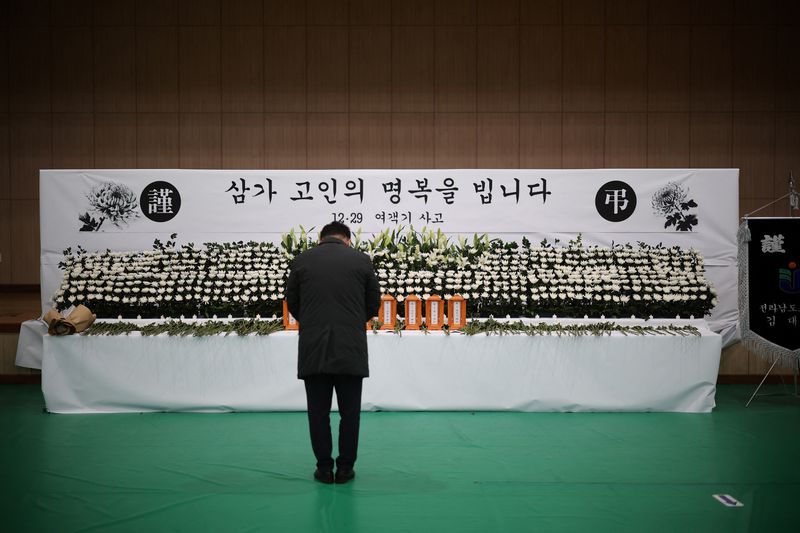 &copy; Reuters. Homem reverencia altar memorial para funcionários do Departamento de Educação de Jeollanam-do e estudantes que morreram no acidente aéreo no Aeroporto Internacional de Muann31/12/2024nREUTERS/Kim Hong-Ji