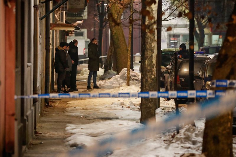 © Reuters. Police and security personnel stand on a street in front of a fire truck, near the scene where a gunman opened fire in a restaurant and killed several people in Cetinje, Montenegro January 1, 2025. REUTERS/ Steve Vasiljevic