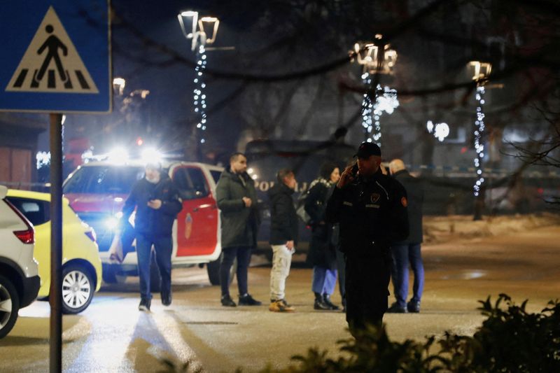 © Reuters. Police and security personnel stand on a street in front of a firetruck near the scene scene where a gunman opened fire at a restaurant and killed several people in Cetinje, Montenegro, January 1, 2025. REUTERS/Stevo Vasiljevic