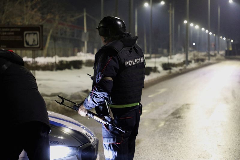 © Reuters. Police members stand on a checkpoint near where a gunman opened fire at a restaurant and killed several people in Cetinje, Montenegro, January 1, 2025. REUTERS/Stevo Vasiljevic