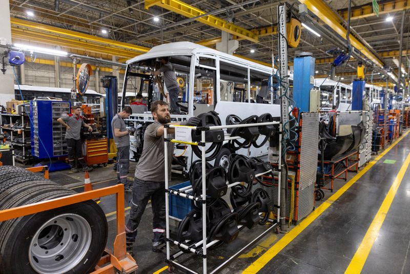 © Reuters. FILE PHOTO: Technicians work on a bus at a production line of Turkey's heavy commercial and armored vehicle manufacturer Otokar factory in Arifiye, a town in Sakarya province, Turkey, July 13, 2023. REUTERS/Umit Bektas/FIle photo