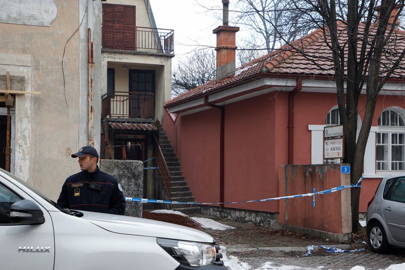 © Reuters. A police officer stands guard in front of restaurant where gunman opened fire and killed several people in Cetinje, Montenegro, January 2, 2025. REUTERS/Stevo Vasiljevic