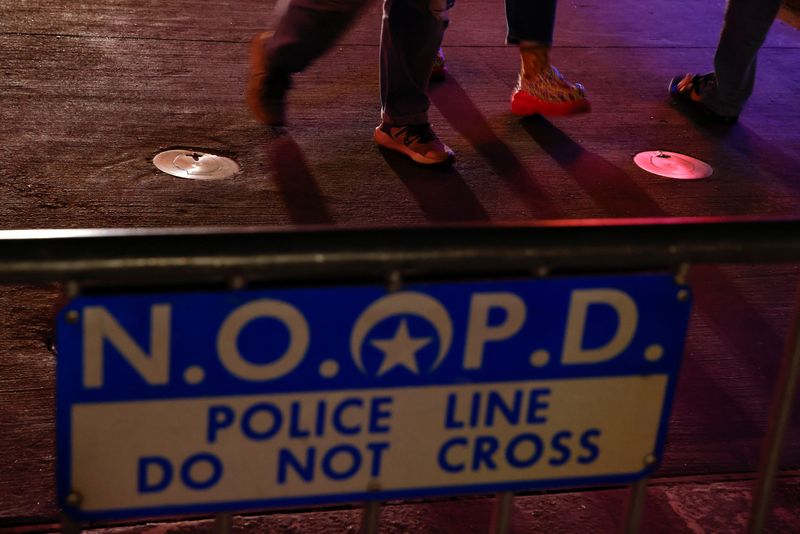 &copy; Reuters. FILE PHOTO: People walk near a police barricade, after people were killed by a man driving a truck in an attack during New Year's celebrations, in New Orleans, Louisiana, U.S., January 2, 2025. REUTERS/Eduardo Munoz/File Photo