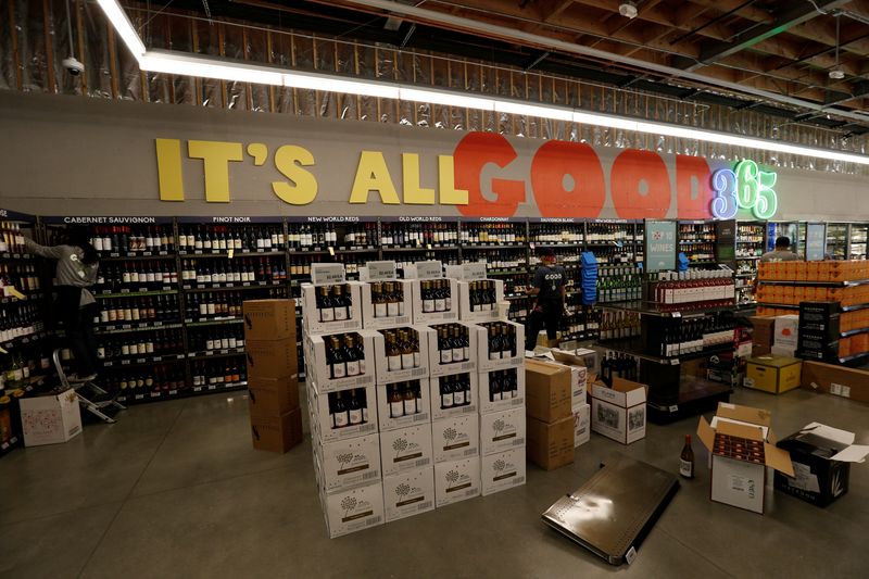 &copy; Reuters. FILE PHOTO: Employees arrange wine at a 365 by Whole Foods Market grocery store is pictured ahead of its opening day in Los Angeles, U.S., May 24, 2016. REUTERS/Mario Anzuoni/File Photo