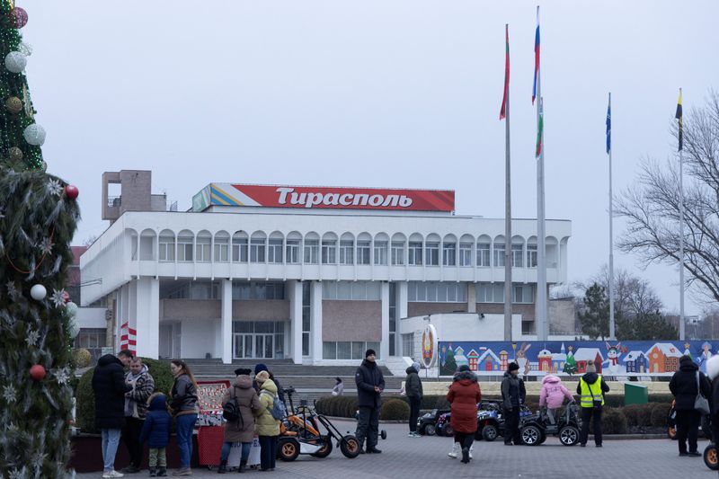 © Reuters. People gather near a Christmas tree in a square in Tiraspol, Moldova's breakaway region of Transdniestria, January 3, 2025. Photograph: Vladislav Bachev/Reuters.