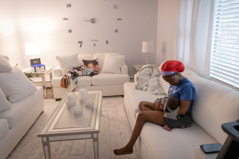 &copy; Reuters. FILE PHOTO: Accountant Aliyah Ponton, 25, breastfeeds Savion, her newborn son, while she sits in her living room in Sparta, New Jersey, U.S., February 25, 2023.     REUTERS/Joy Malone/File Photo