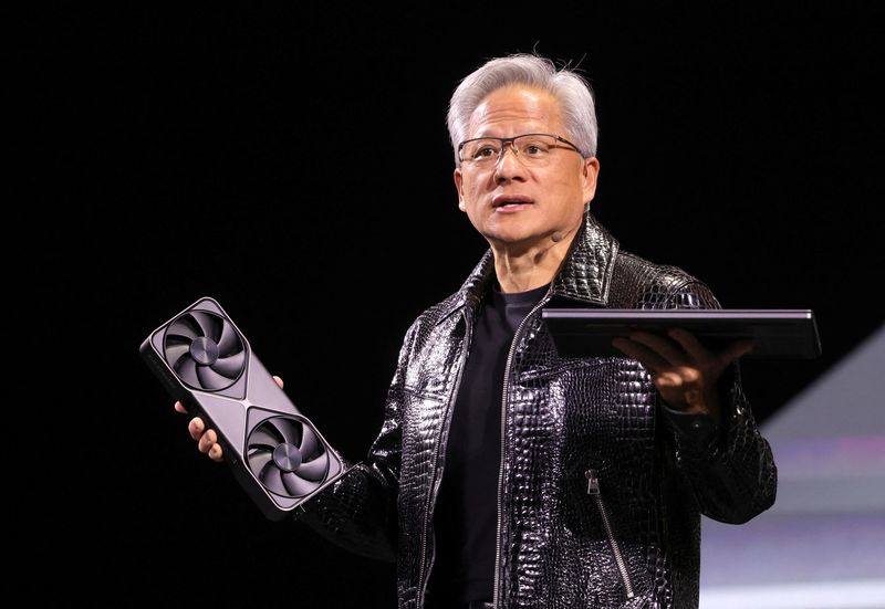 &copy; Reuters. Nvidia CEO Jensen Huang holds a new Nvidia GeForce RTX 5090 graphics card and an RTX 5070 laptop as he gives a keynote address at CES 2025, an annual consumer electronics trade show, in Las Vegas, Nevada, U.S. January 6, 2025.  REUTERS/Steve Marcus/File P