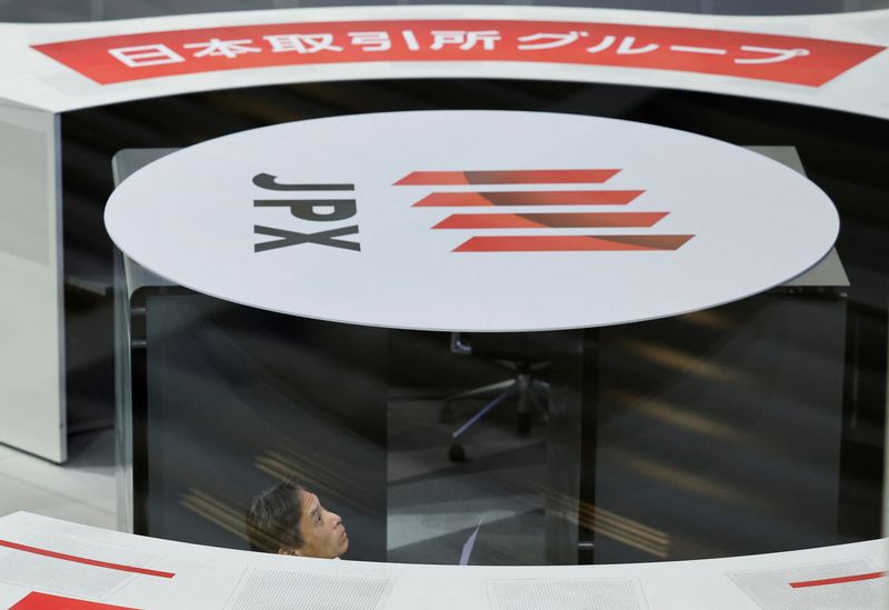 © Reuters. FILE PHOTO: A staff of the Tokyo Stock Exchange (TSE) looks at a stock quotation board after a ceremony marking the end of trading in 2024 at the TSE in Tokyo, Japan December 30, 2024. REUTERS/Kim Kyung-Hoon/ File Photo
