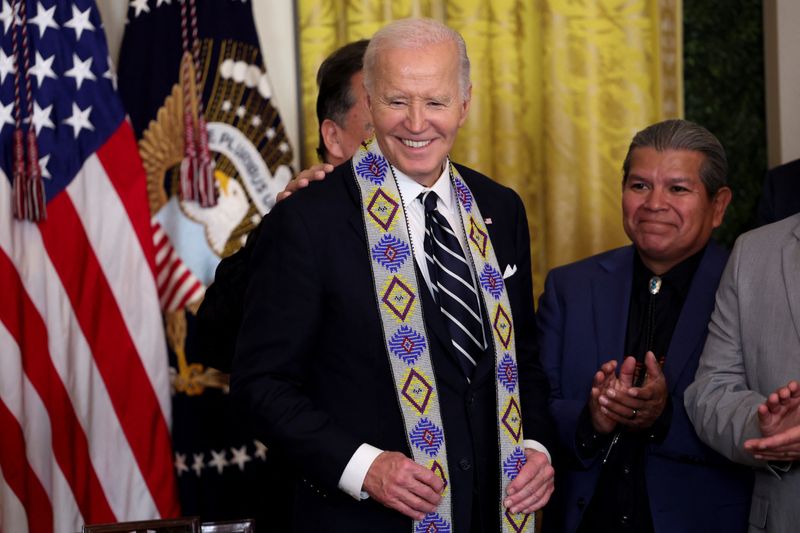 &copy; Reuters. U.S. President Joe Biden wears a ceremonial sash as he attends an event held to establish the Chuckwalla National Monument and the Sattitla Highlands National Monument in California, at the White House in Washington, U.S., January 14, 2025. REUTERS/Kevin 