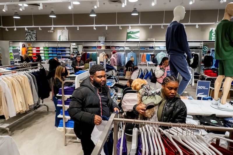 &copy; Reuters. FILE PHOTO: Black Friday shoppers pick out clothing in a Lacoste store as retailers compete to attract shoppers and try to maintain margins on Black Friday, one of the busiest shopping days of the year, at Woodbury Common Premium Outlets in Central Valley