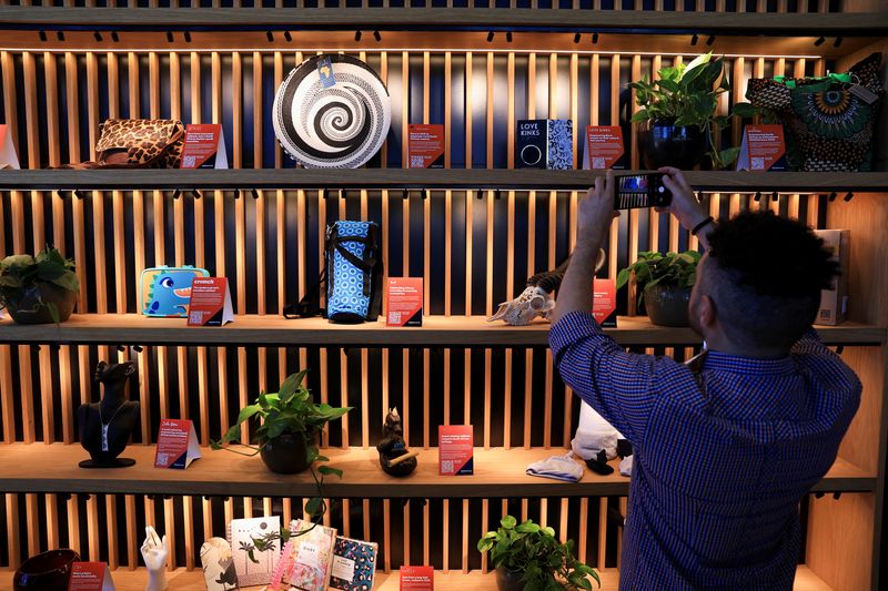 &copy; Reuters. A person photographs some of the products that are on display at the U.S. e-commerce giant Amazon.com launch centre for its independent sellers in Cape Town, South Africa, January 16, 2025. REUTERS/Esa Alexander