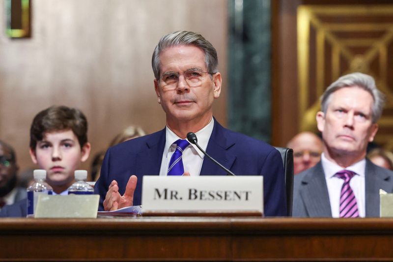 © Reuters. Scott Bessent, U.S. President-elect Donald Trump's nominee to be secretary of treasury, looks on next to his husband John Freeman and son Cole, on the day he testifies during a Senate Committee on Finance confirmation hearing on Capitol Hill in Washington, U.S., January 16, 2025. REUTERS/Kevin Lamarque