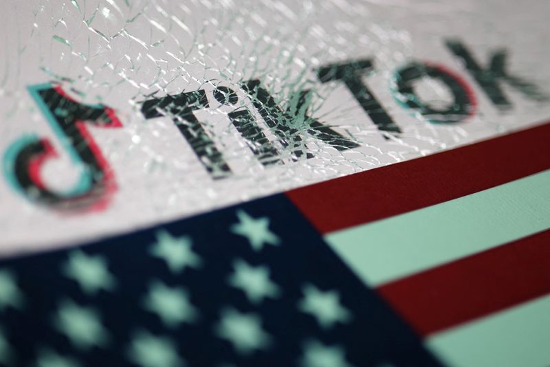 © Reuters. An American flag and the TikTok logo seen through broken glass are seen in this photo taken January 16, 2025. REUTERS/Dado Ruvic/Illustration