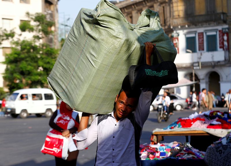 © Reuters. A worker carries goods for shops at Al Ataba, in Cairo, Egypt June 16, 2019. REUTERS/Mohamed Abd El Ghany/File Photo