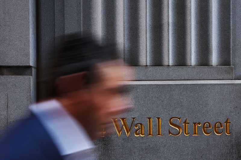 © Reuters. A man walks past a Wall Street marking outside the New York Stock Exchange (NYSE) building on Tuesday following Monday’s broad sell off in New York City, U.S., March 11, 2025. REUTERS/Shannon Stapleton