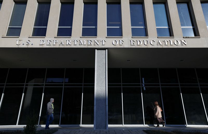 &copy; Reuters. People walk in front of the Department of Education building, amid reports that U.S. President Donald Trump's administration will take steps to defund the federal Education Department, in Washington, U.S., February 4, 2025. REUTERS/Kevin Lamarque