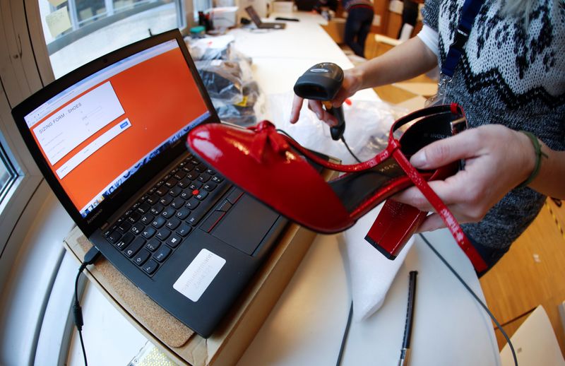 &copy; Reuters. FILE PHOTO: A fitting model enters data in a laptop after she checks out sizes for a shoe which goes on sale at the online shop of fashion retailer Zalando in Berlin, Germany, December 17, 2018.  REUTERS/Fabrizio Bensch/File Photo