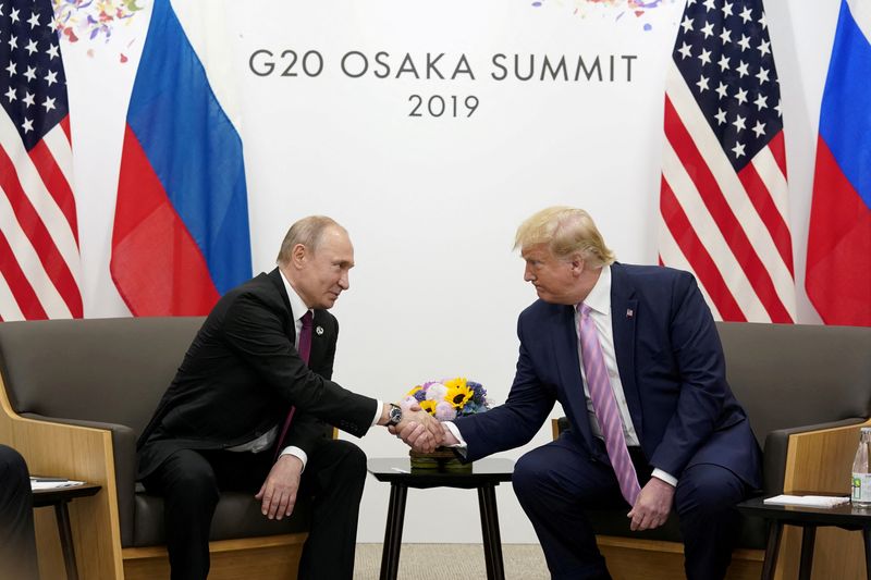 &copy; Reuters. FILE PHOTO: Russia's President Vladimir Putin and U.S. President Donald Trump shake hands during a bilateral meeting at the G20 leaders summit in Osaka, Japan, June 28, 2019.  REUTERS/Kevin Lamarque/File Photo