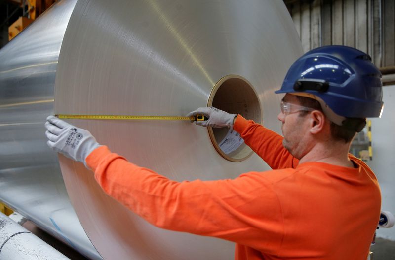 &copy; Reuters. FILE PHOTO: A worker measures the diameter of a coil of aluminium at the Neuf-Brisach Constellium aluminium products company's production unit in Biesheim, Eastern France, April 9, 2018.  REUTERS/Vincent Kessler/File Photo