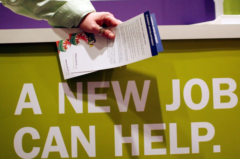 &copy; Reuters. FILE PHOTO: A man holds pamphlets as he waits at a job fair sponsored by employment website Monster.com as part of their "Keep America Working" tour at a hotel in New York's Times Square, March 5, 2009.  REUTERS/Mike Segar/File Photo