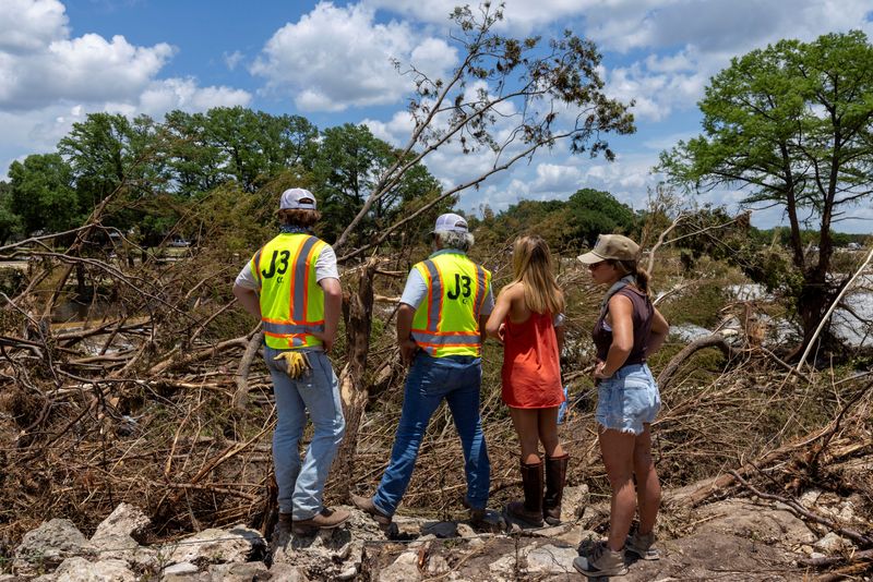 &copy; Reuters. FILE PHOTO: People take part in the search and rescue operation looking for missing people by the Guadalupe River, in Hunt, Texas, U.S. July 9, 2025. REUTERS/Umit Bektas/File Photo