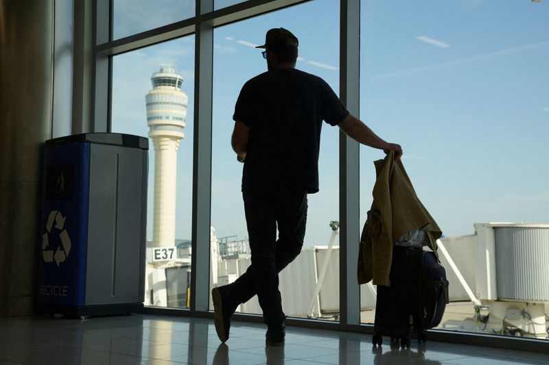 &copy; Reuters. FILE PHOTO: The air traffic control tower can be seen from the Hartsfield Jackson Atlanta International Airport terminal, in Atlanta, Georgia, U.S. May 15, 2025.  REUTERS/Megan Varner/File Photo